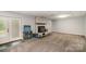 Finished basement boasting a cozy fireplace with a brick surround and a walkout to the backyard at 1565 Oakridge Dr, Salisbury, NC 28146
