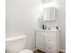 Bright bathroom featuring a white vanity, mirrored cabinet, and standard toilet at 1565 Oakridge Dr, Salisbury, NC 28146