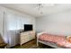 Bright bedroom featuring wood-look floors, a ceiling fan, and a large window for natural light at 1565 Oakridge Dr, Salisbury, NC 28146