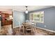 Cozy dining area with a window, wood-look floors, and stylish light fixture at 1565 Oakridge Dr, Salisbury, NC 28146