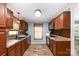 Well-lit kitchen with stainless steel appliances, stylish backsplash, and custom cabinets at 1565 Oakridge Dr, Salisbury, NC 28146