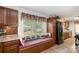 Bright eat-in kitchen nook with a window seat, wood cabinetry, and charming decor at 1565 Oakridge Dr, Salisbury, NC 28146