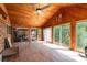 Spacious sunroom with wood paneling, ceiling fan, and lots of natural light from expansive windows at 1565 Oakridge Dr, Salisbury, NC 28146