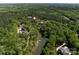 Waterfront property highlighted from the air, surrounded by lush greenery at 16518 Here At Last Ln, Charlotte, NC 28278