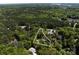 Wide aerial shot of a home surrounded by green trees showcasing its location at 16518 Here At Last Ln, Charlotte, NC 28278