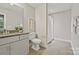 Bathroom features a vanity, toilet, shower with a curtain, and a towel rack at 16518 Here At Last Ln, Charlotte, NC 28278