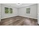 Bright bedroom features hardwood floors and two windows with natural light at 16518 Here At Last Ln, Charlotte, NC 28278
