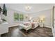 The bedroom has hardwood floors, a crystal light fixture, and lots of natural light at 16518 Here At Last Ln, Charlotte, NC 28278