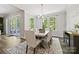 Bright dining area featuring large windows with natural light and an elegant chandelier above the table at 16518 Here At Last Ln, Charlotte, NC 28278