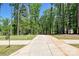 Long driveway leading to a secluded property, surrounded by mature trees and lush greenery at 16518 Here At Last Ln, Charlotte, NC 28278