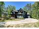 Charming home with a large driveway and attached garage, nestled in a serene, wooded setting at 16518 Here At Last Ln, Charlotte, NC 28278