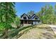A lovely home with a welcoming front porch set against a backdrop of mature trees and lush greenery at 16518 Here At Last Ln, Charlotte, NC 28278