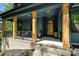 Inviting front porch with wood columns and dark blue siding offering an appealing entry at 16518 Here At Last Ln, Charlotte, NC 28278