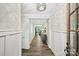 Elegant hallway with decorative lighting, wood floors, and stylish wainscoting at 16518 Here At Last Ln, Charlotte, NC 28278