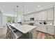 Open kitchen with an island, pendant lighting, stainless steel appliances, and view into the dining area at 16518 Here At Last Ln, Charlotte, NC 28278