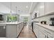 Modern kitchen design with stainless steel appliances, island with sink and view into the dining area at 16518 Here At Last Ln, Charlotte, NC 28278