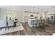 Modern kitchen and dining area featuring a center island with bar seating and stainless steel appliances at 16518 Here At Last Ln, Charlotte, NC 28278