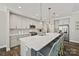 Modern kitchen boasts a large island with seating, stainless steel appliances, and stylish pendant lighting at 16518 Here At Last Ln, Charlotte, NC 28278