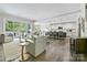 Open-concept living area with a large sliding door and a modern kitchen and island bar at 16518 Here At Last Ln, Charlotte, NC 28278
