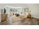The living room has hardwood floors, comfortable seating, and plenty of natural light at 16518 Here At Last Ln, Charlotte, NC 28278