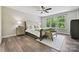 Inviting bedroom with large windows, cozy chair, and natural light at 16518 Here At Last Ln, Charlotte, NC 28278