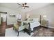 The main bedroom features a ceiling fan, tufted headboard, bedside tables, and an ensuite bathroom at 16518 Here At Last Ln, Charlotte, NC 28278