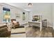 The office has dark wood floors, two windows, and a built-in desk with shelving at 16518 Here At Last Ln, Charlotte, NC 28278