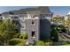 Building exterior featuring gray wooden shingles and lush green landscaping at 18723 Vineyard Point Ln, Cornelius, NC 28031