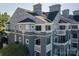 Low angle of a building's exterior, showing the decks and beautiful architecture at 18723 Vineyard Point Ln, Cornelius, NC 28031