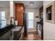 Kitchen featuring dark wood cabinetry, black countertops, and stainless steel appliances at 18723 Vineyard Point Ln, Cornelius, NC 28031
