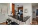 Galley kitchen with dark cabinets, breakfast bar, and modern stainless steel appliances at 18723 Vineyard Point Ln, Cornelius, NC 28031