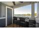 Enjoy beautiful lake views from this patio with outdoor furniture and chairs at 18723 Vineyard Point Ln, Cornelius, NC 28031