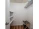 This walk-in closet features custom shelving, a clothes rack, and wood-look vinyl flooring at 18723 Vineyard Point Ln, Cornelius, NC 28031