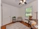 Inviting bedroom space with a chair, shelves, and a large window that provides ample natural light at 216 Wakefield Dr # B, Charlotte, NC 28209