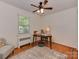 Cozy bedroom with a ceiling fan, natural light, and hard wood floors perfect for a home office setup at 216 Wakefield Dr # B, Charlotte, NC 28209