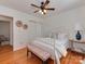 Serene bedroom with hardwood floors, a ceiling fan, and a comfortable white bed at 216 Wakefield Dr # B, Charlotte, NC 28209