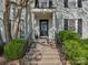 Inviting front entrance with concrete steps, black railing and well-manicured bushes at 216 Wakefield Dr # B, Charlotte, NC 28209