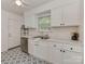 A bright kitchen featuring white cabinets, stainless steel appliances, and patterned flooring at 216 Wakefield Dr # B, Charlotte, NC 28209