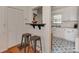 A well-lit kitchen featuring a breakfast bar, white cabinets, and an eye-catching patterned floor at 216 Wakefield Dr # B, Charlotte, NC 28209