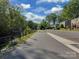View of the green neighborhood with the walking trail, trees, and well maintained streets and sidewalks at 216 Wakefield Dr # B, Charlotte, NC 28209