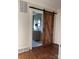 Bathroom with modern vanity, a framed mirror, and a rustic barn-style sliding door at 240 North Ave, Troutman, NC 28166