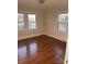 Cozy bedroom featuring hardwood floors and natural light from multiple windows at 240 North Ave, Troutman, NC 28166