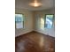 Sunlit bedroom with two windows, refinished hardwood floors, and fresh paint at 240 North Ave, Troutman, NC 28166