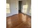 Bright bedroom featuring hardwood floors, white trim and doors, and ample natural light at 240 North Ave, Troutman, NC 28166