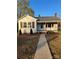 Charming single-story home with a walkway leading to the covered porch entrance at 240 North Ave, Troutman, NC 28166