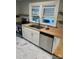 Bright kitchen featuring stainless steel appliances, white cabinets, and butcher block countertops at 240 North Ave, Troutman, NC 28166