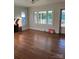 Bright living room featuring hardwood floors, a fireplace, and plentiful natural light at 240 North Ave, Troutman, NC 28166