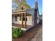 Cozy single-story home featuring a covered porch and an adjacent brick chimney at 240 North Ave, Troutman, NC 28166