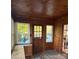Cozy wood-paneled sunroom with multiple windows offering natural light and backyard view at 240 North Ave, Troutman, NC 28166