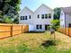 Back of the home featuring a fenced yard and freshly planted tree, great for entertaining at 2505 Elon St, Charlotte, NC 28208